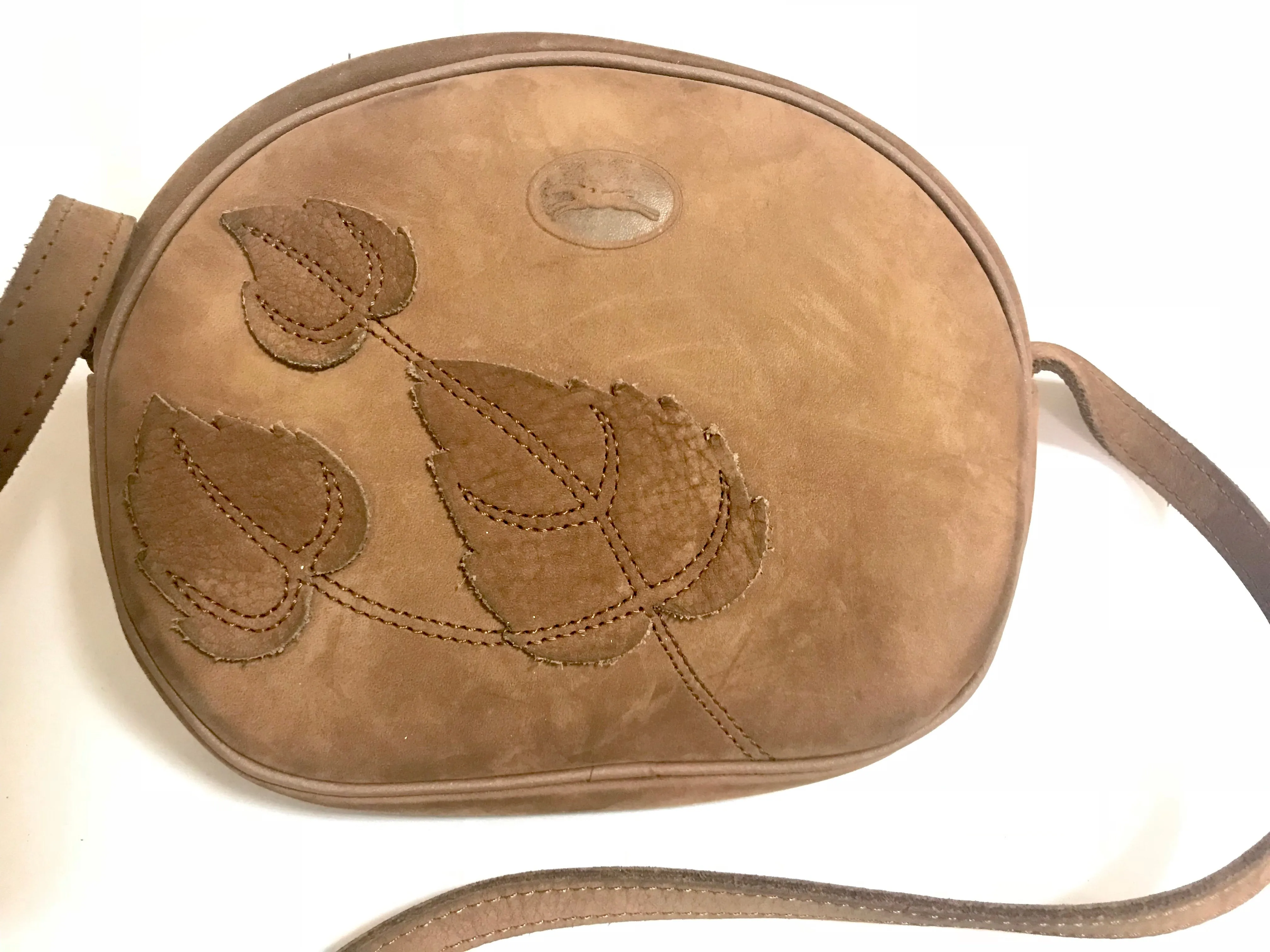 Vintage Longchamp brown suede leather oval round shape shoulder bag with leaf applique motifs. Rare and unique bag back in the okd era.